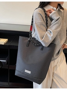 Large gray checkered tote bag with woven rope handles shown on model for daily commute