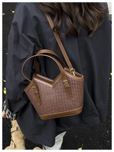 Brown woven texture tote bag with leather strap shown in a stylish street style setting