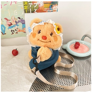 Detailed close-up of a cute yellow plush bear backpack with a denim outfit and sun hat