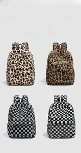 Macro view of plush backpacks in leopard and checkerboard patterns for women