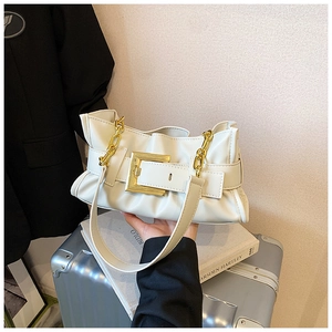 Detail showing the creamy white pleated leather texture and gold buckle on the shoulder bag
