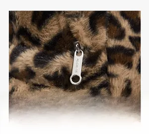 Macro shot of silver zipper puller on leopard print faux fur backpack texture
