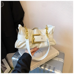 Detailed view of cream pleated shoulder bag with gold hardware and thick chain strap