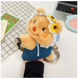 Detail of plush bear backpack with sunflower hat and adjustable strap on a cozy desk