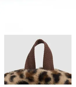 Detail of durable brown nylon handle and soft leopard faux fur on plush backpack