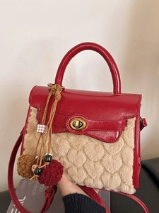 Faux fur handbag with red patent leather accents and embossed heart patterns on beige plush