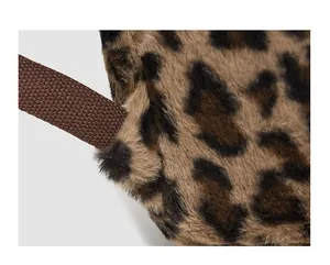 Detail showing reinforced stitching on the leopard plush backpack's durable shoulder strap