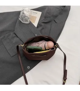 Top view of brown bucket bag interior showing capacity for umbrella and phone