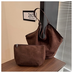 Detailed view of dark brown suede tote bag set with a matching small zipper pouch