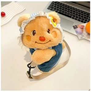 Close-up of yellow teddy bear plush backpack featuring denim overalls and floral hat