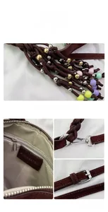 Close-up of brown suede bag details with beaded strap, herringbone lining and silver hardware