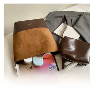 Detail view of large bucket bag interior showing capacity for tablets and cosmetics