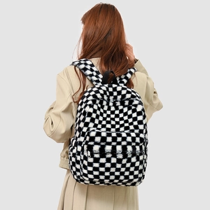 Rear view of a plush checkerboard backpack with soft faux fur texture and silver zipper