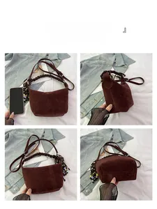 Detailed views of the brown suede hobo bag with braided handle and colorful tassel charm