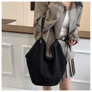 Side view of black suede tote bag showing large capacity and minimalist sleek design