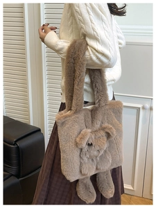 Detail of soft brown faux fur tote bag with cute plush doll and wide shoulder strap