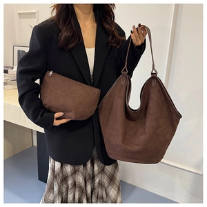 Detail of dark brown matte suede tote bag set with matching zipper clutch pouch