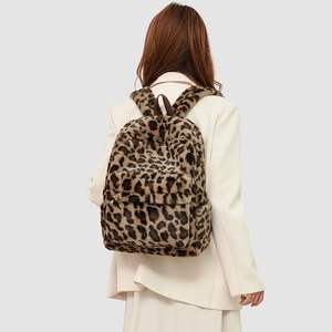 Close-up of plush leopard print faux fur texture and zipper detail on the backpack