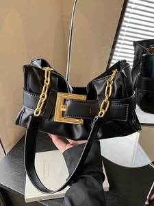 Chic black pleated underarm bag with a bold gold buckle and chain for stylish women