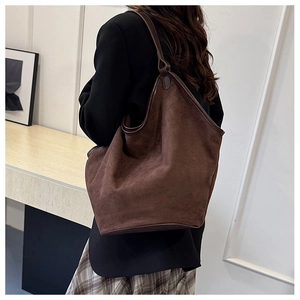 Detail of dark brown matte leather tote bag with stylish trim for autumn fashion