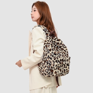 Detail view of the soft leopard print faux fur backpack texture and side carrying style