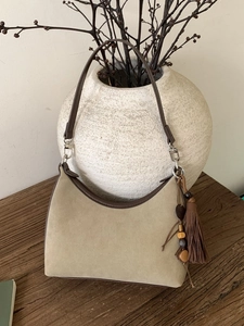 Retro suede hobo shoulder bag with ethnic tassel beads and leather trim in beige