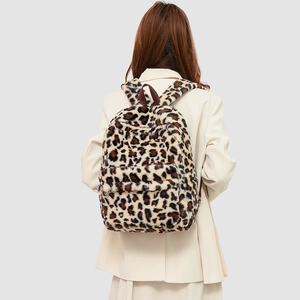Rear view of a plush leopard print faux fur backpack with large capacity and zip pocket