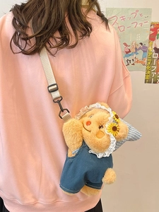 Cute plush bear backpack with blue denim overalls and sunflower lace hat on a model