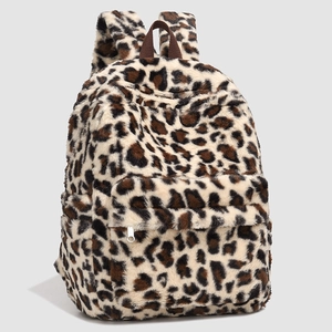 Close-up of fluffy leopard print backpack showing plush texture and front zipper pocket