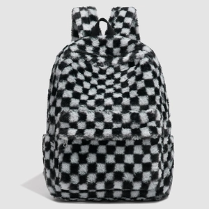 Close-up of black and white checkered plush backpack with soft faux fur texture and front pocket