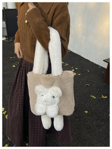Close-up of khaki plush tote bag featuring a cute 3D white bear doll and furry handle