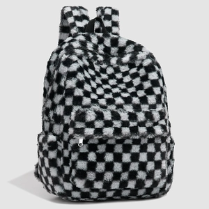 Detail of black and white checkerboard plush backpack with soft faux fur and front pocket