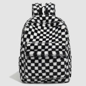 Detail of soft black and white checkerboard plush backpack with front zipper pocket