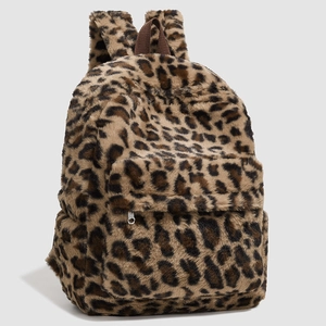 Detailed view of plush leopard print backpack featuring faux fur texture and front zipper pocket