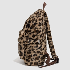 Close-up of leopard print plush backpack showing fuzzy texture and metal zipper details