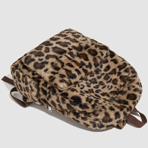 Close-up detail of plush leopard print backpack with soft faux fur texture and silver zipper