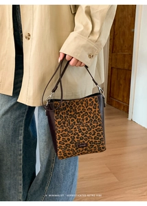 Detail view of leopard print bucket bag featuring NO FILTER logo and slim strap