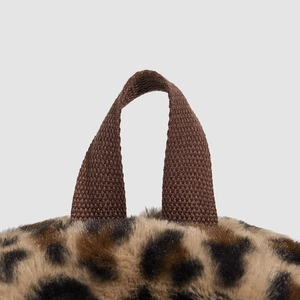 Detail of leopard print faux fur backpack with durable brown woven handle and soft texture