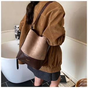 Retro large capacity bucket bag detail showing suede contrast and adjustable strap