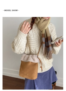 Close-up of brown faux suede bucket bag with soft beige faux fur trim and drawstring detail