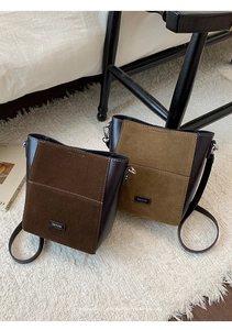 Detail showing vintage patchwork bucket bags in dark brown and olive green faux leather