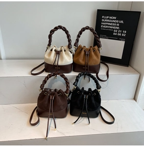 Detail of four colorful bucket bags featuring braided handles and drawstring closures