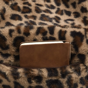 Macro detail of plush leopard print backpack with metal zipper and interior pocket space