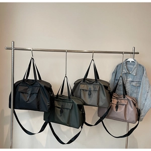 Detail of high-capacity travel bags in four colors with functional front buckle pockets