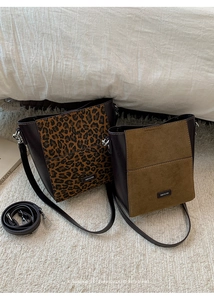 Detail of leopard print and suede bucket bags with metallic NO FILTER branding