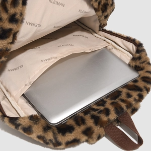 Interior view of leopard print plush backpack featuring a padded laptop compartment