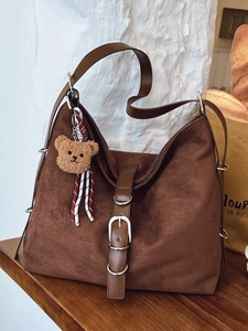 Brown faux suede tote bag with leather strap and teddy bear charm for daily commute