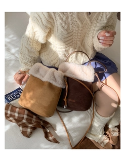 Detail of plush faux fur trim and suede texture on khaki and brown bucket bags