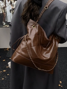 Deep brown quilted tote bag with chain strap and shiny finish for women autumn style