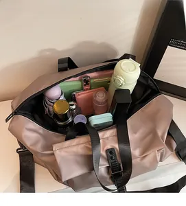 Top view of pink travel bag interior showing large capacity for water bottle and umbrella